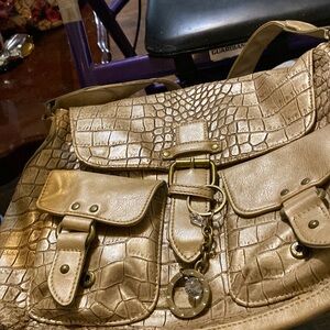 Nine and Company shoulder bag, gold with front pockets & charms.